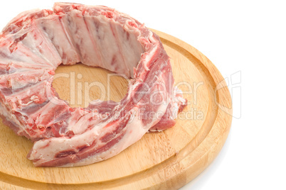 Uncooked Pork ribs on round hardboard