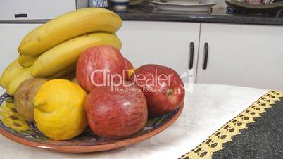 Fruit banana apples lemon on table