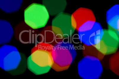 Blurred holiday colorful lights over black