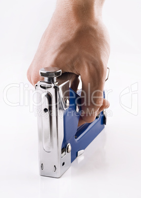 Staple gun in man's arm over white