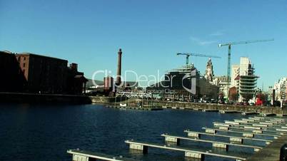 View of construction cranes across dock buildings