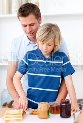 Attentive father helping his son prepare the breakfast