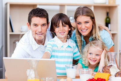 Loving family using laptop during the breakfast