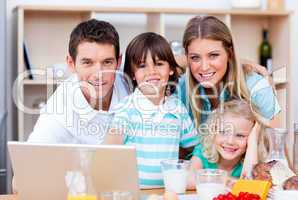 Loving family using laptop during the breakfast
