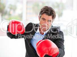 Furious businessman wearing boxing gloves