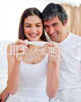 Glowing couple finding out results of a pregnancy test