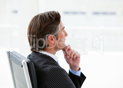 Pensive male executive sitting in his office