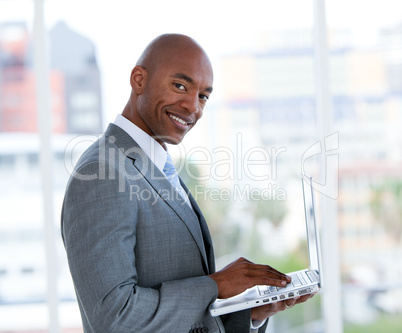 Portrait of a serious businessman working at a laptop