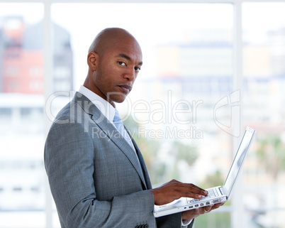 Portrait of a confident businessman working at a laptop