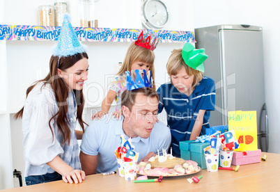 Elegant man celebrating his birthday with his wife and his child