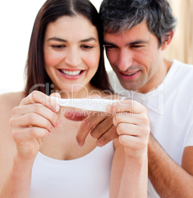 Blissful couple finding out results of a pregnancy test