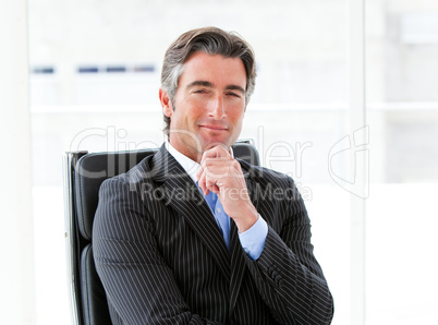 Ambitious male executive sitting in his office