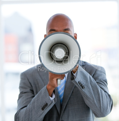 Ethnic businessman yelling through a megaphone