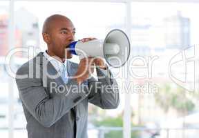 Ambitious businessman yelling through a megaphone
