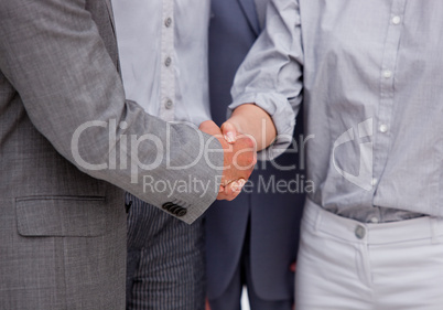 Close-up of a victorious businessteam closing a deal