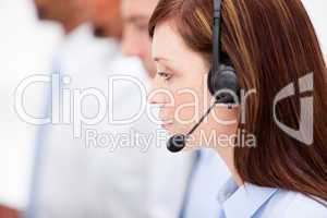 Close-up of a female customer service agent and her team
