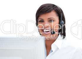 Portrait of a smiling customer service agent working at a comput