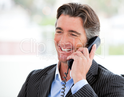 Portrait of a smiling businessman on phone