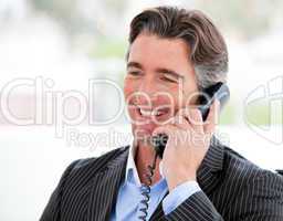 Portrait of a smiling businessman on phone