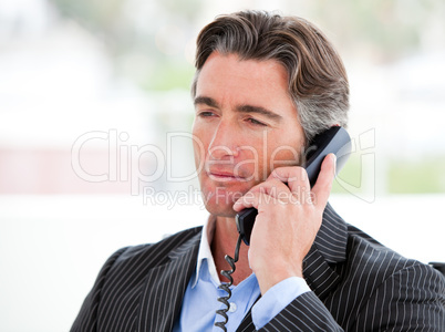 Portrait of a self-assured businessman on phone