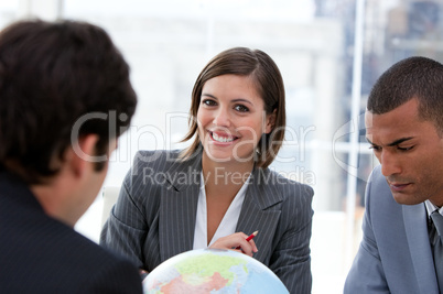 Fortunate businessteam looking at a terrestrial globe