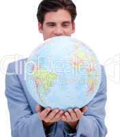 Portrait of an ambitious man holding a terrestrial globe