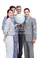Successful businessteam looking at a terrestrial globe