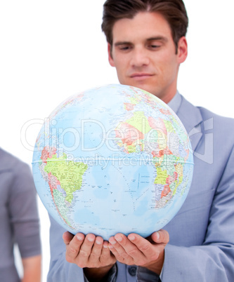 Portrait of a confident man holding a terrestrial globe