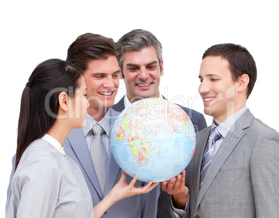 Positive businessteam looking at a terrestrial globe