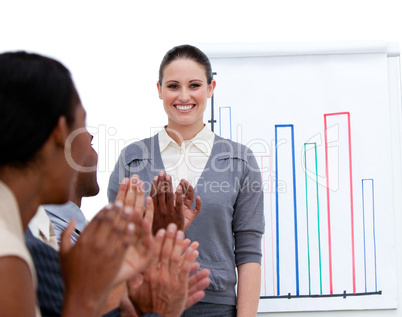 Smiling businesswoman presenting statistics in a company