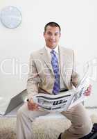Charming manager reading a newspaper