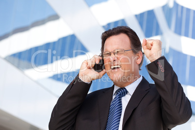 Excited Businessman on Cell Phone