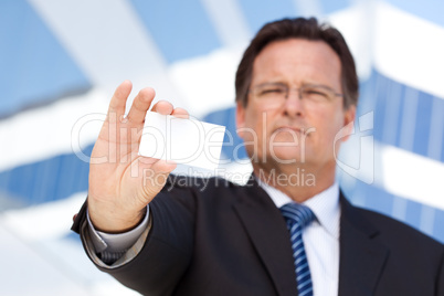 Handsome Businessman Holds Out Blank Business Card