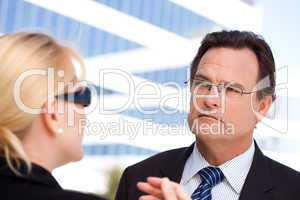 Businessman Listens to Female Colleague