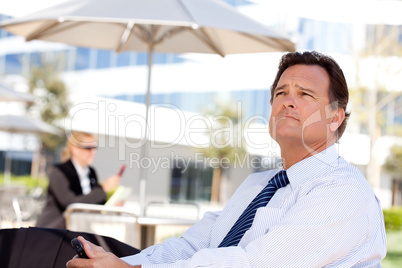 Handsome Businessman Looks Off Into the Distance