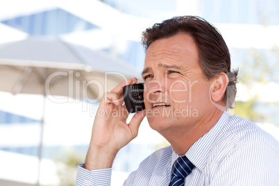 Businessman Smiles as He Talks on His Cell Phone
