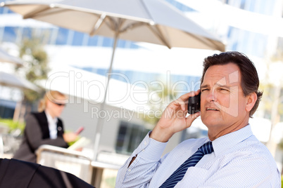 Businessman Smiles as He Talks on His Cell Phone