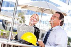 Businesswoman and Man Laughing While Working