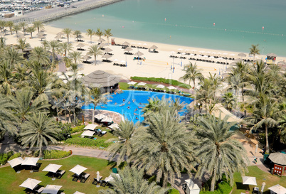 Fitness exercises in swimming pool at the beach of luxury hotel,