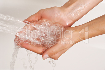 Hands under a stream of shower