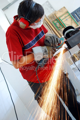 metal worker with grinder