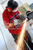 metal worker with grinder