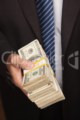 Businessman Handing Over Stack of Cash