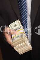 Businessman Handing Over Stack of Cash