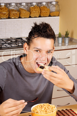 Young man having breakfast at home