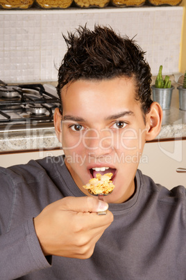Young man eating cornflakes