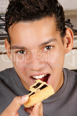 Young man eating fruit tart