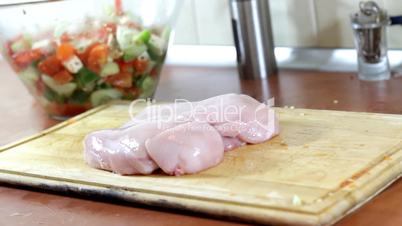 Slicing chicken breast meat