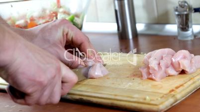 Slicing chicken breast meat