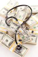 Question Mark Shaped Stethoscope Laying on Money